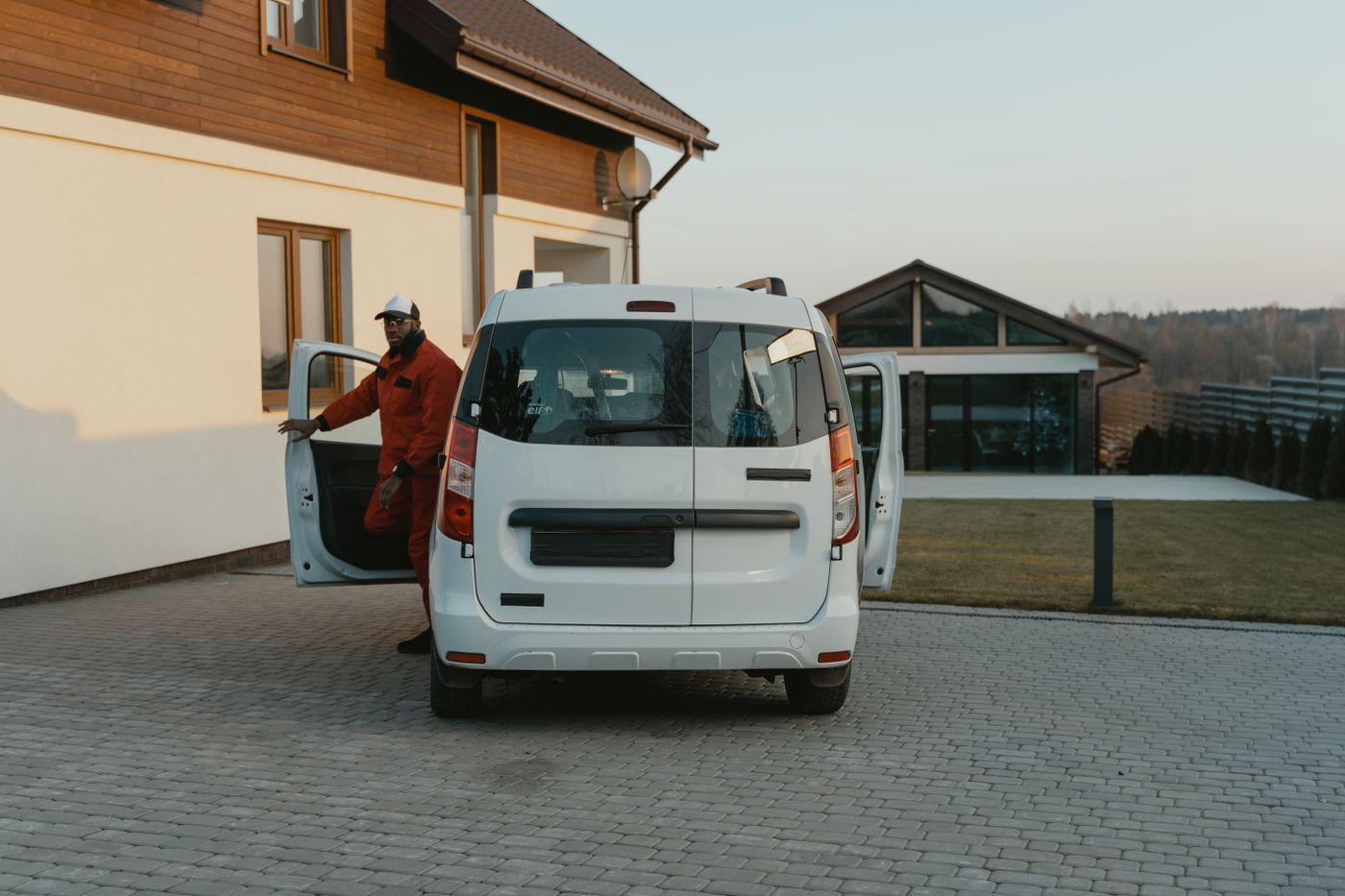 Professional arriving in a white service van at a home